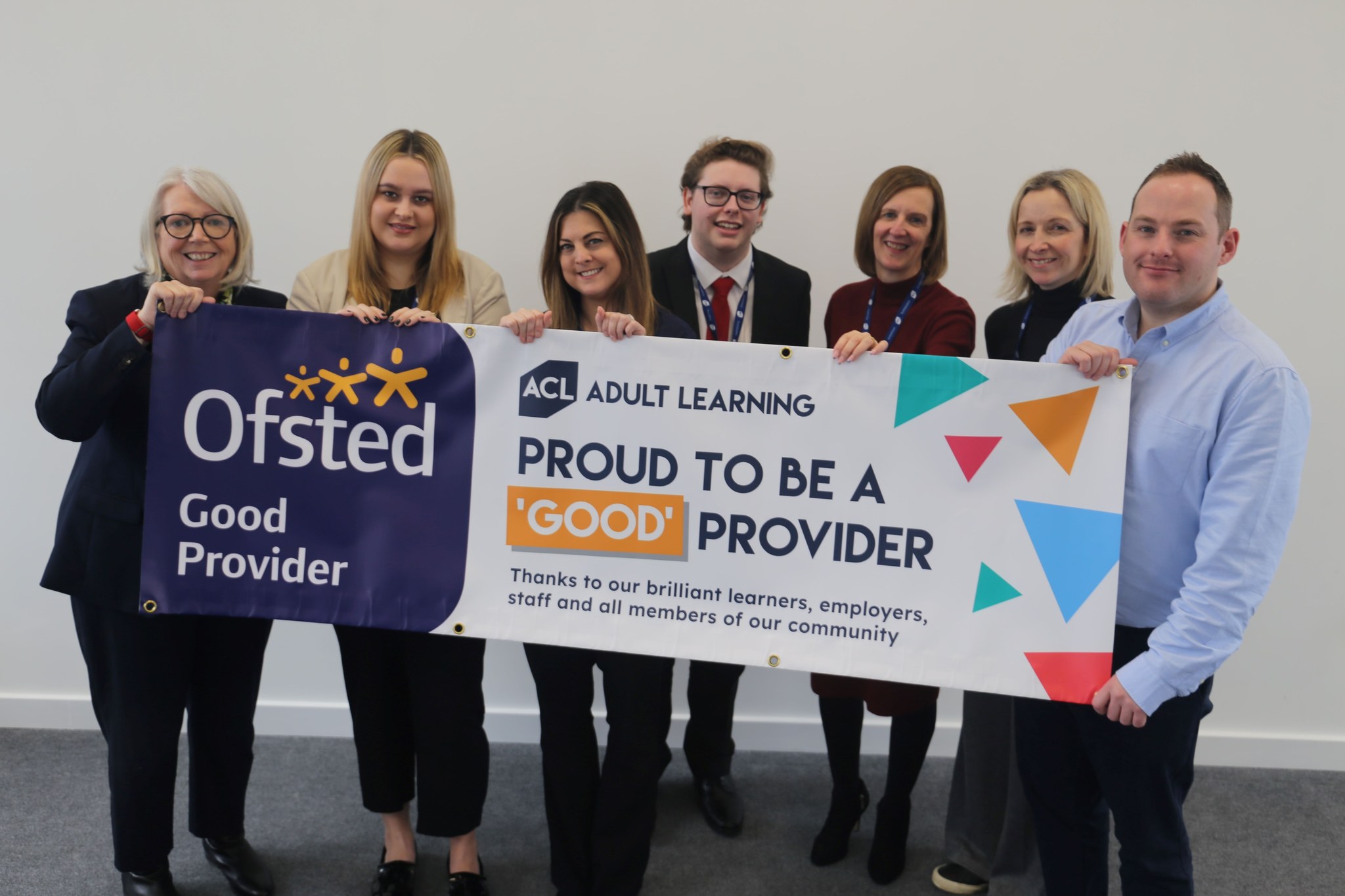 ACL staff holding Ofsted banner