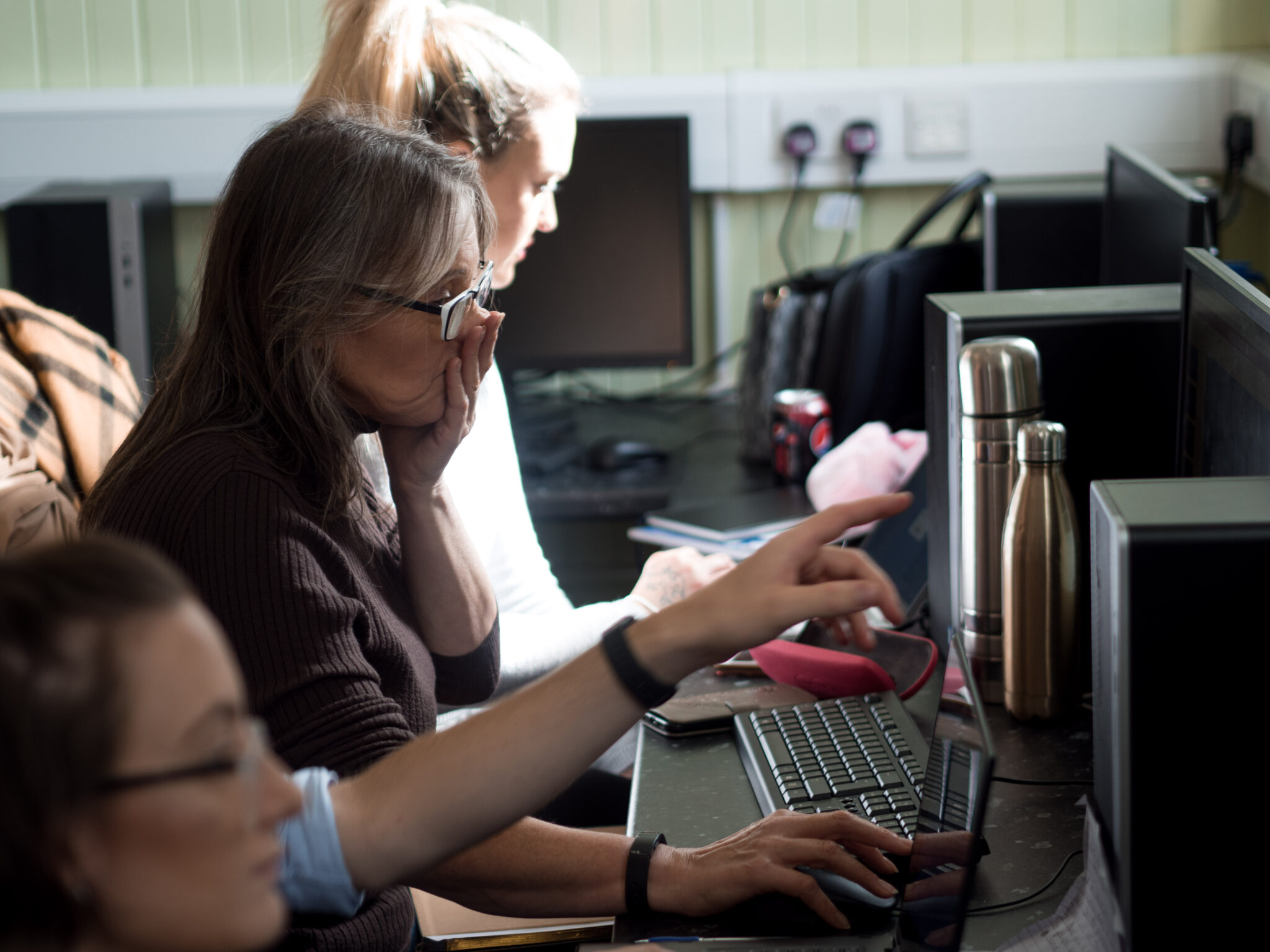 Tutor pointing to computer