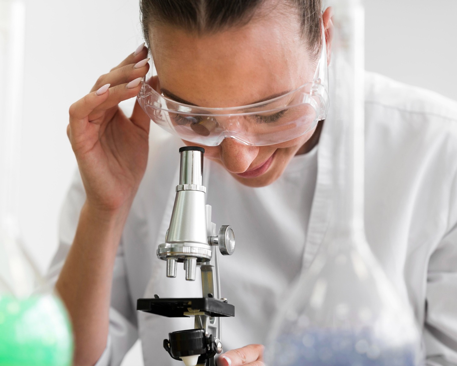 Person looking through microscope