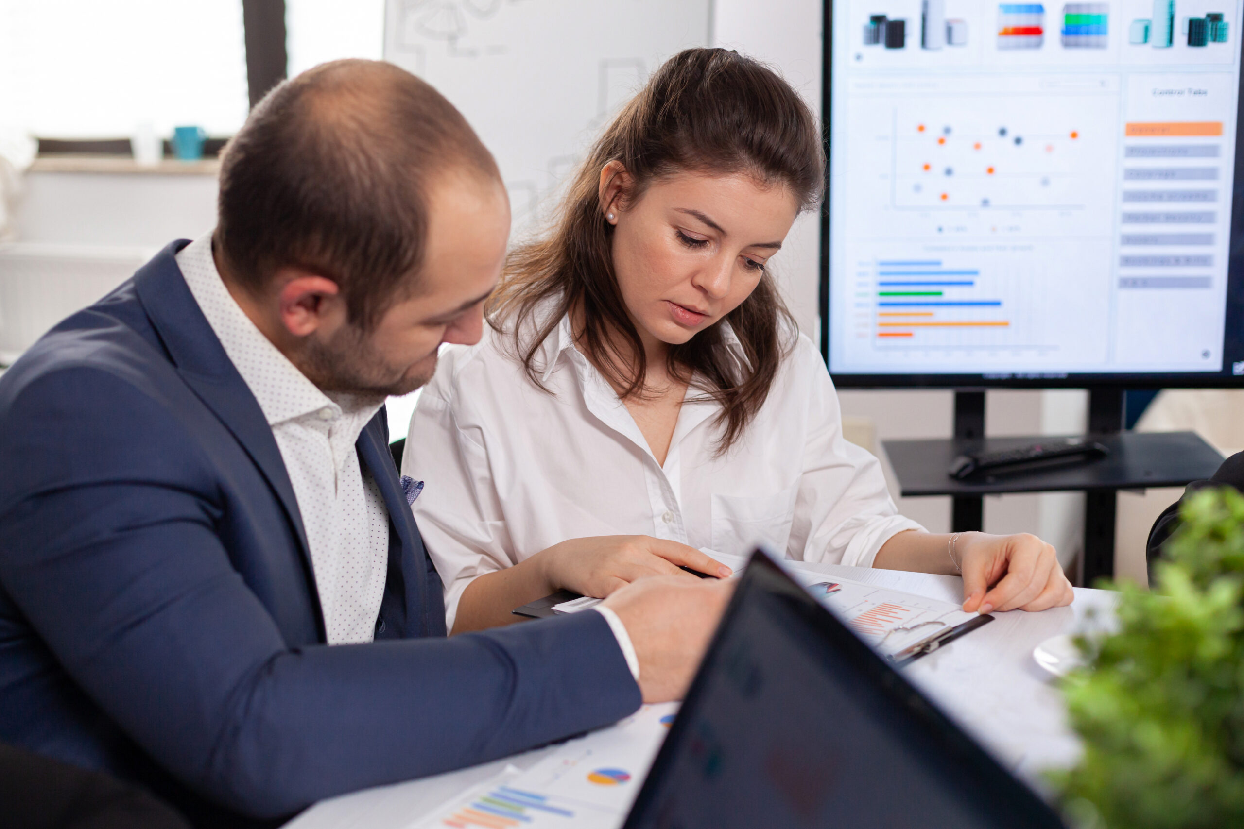 Colleagues of startup business discussing looking at documents