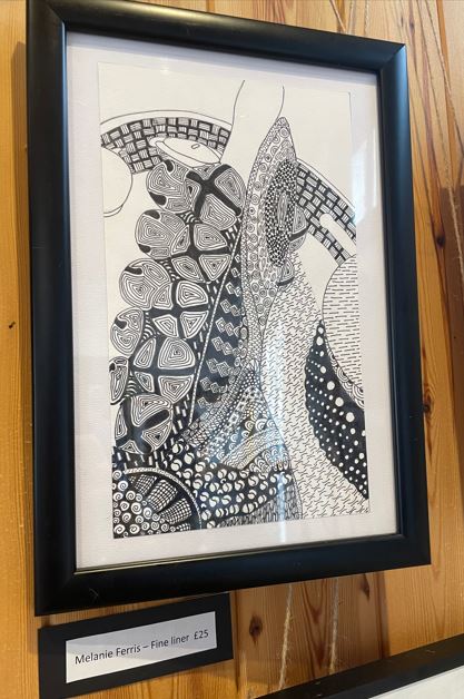 Black and white patterns, black frame , wall mounted picture displayed.