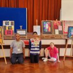 Group amongst paintings