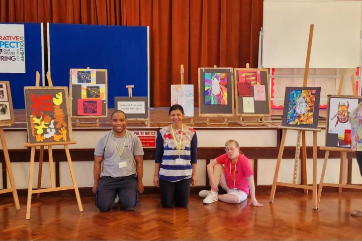 Group amongst paintings