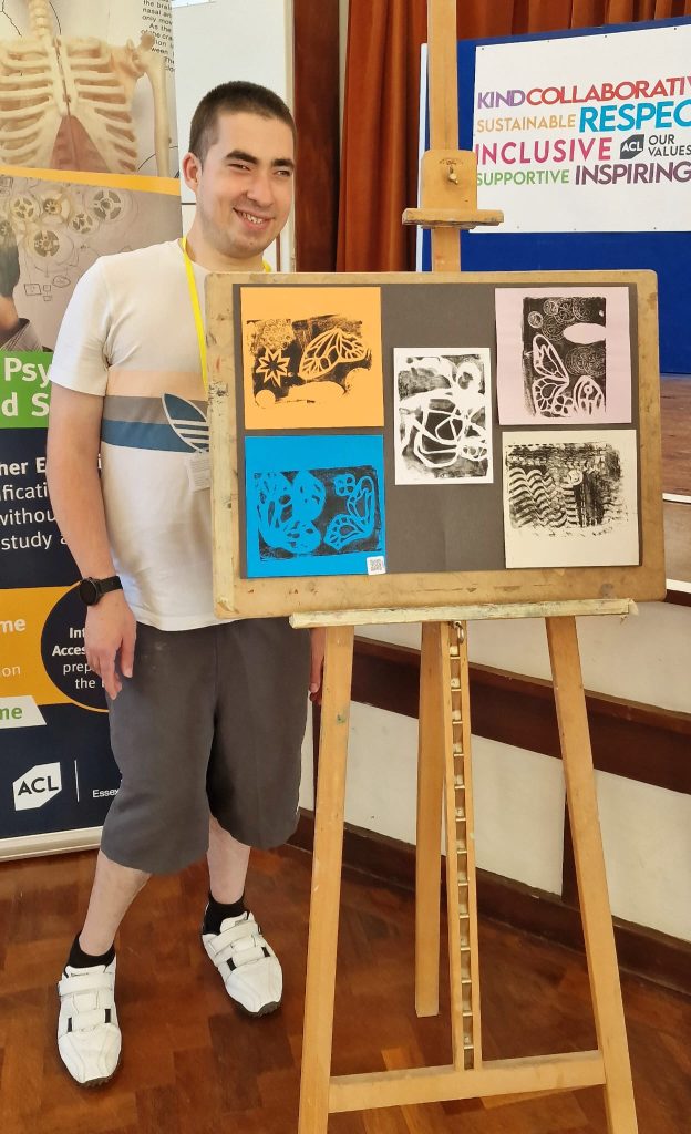 Man standing next to art work