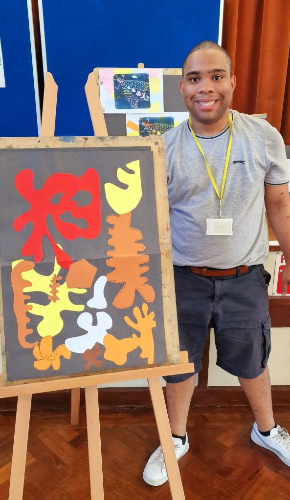 Man standing next to art work