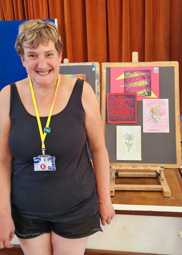 Lady standing next to art work